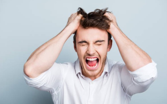 A frustrated man pulling his hair out because the film stopped